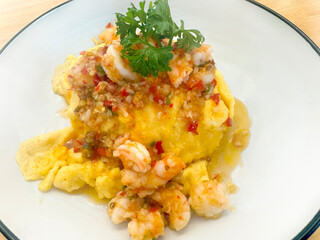 Minced shrimp omelet topped with fish sauce,Chopped chilli on a white plate.