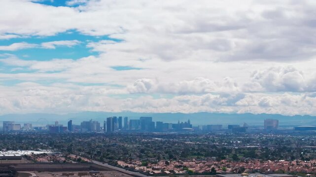 Telephoto drone shot of the Las Vegas Strip on a sunny day with clouds