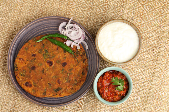 Methi or Fenugreek paratha or methi thepla with tomato chutney a Maharashtrian and Gujarati breakfast