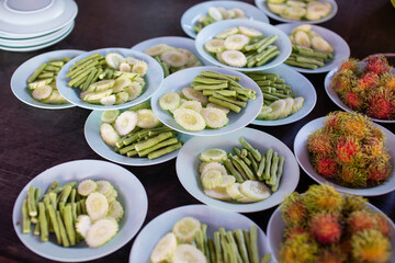Fruits and vegetables placed in blue plastic plates