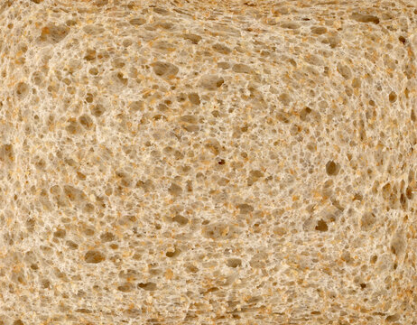 Slice of  high fibre brown wholemeal bread close up texture detail background