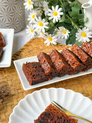 Kek Buah Kukus, a traditional Malaysian steamed fruit cake filled with dried fruits, nuts, and spices, enjoyed during celebrations.