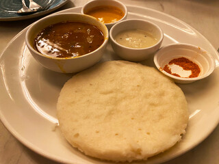 Enjoy the crispy dosa paired with the tangy, flavorful sambhar and creamy coconut chutney for an authentic South Indian culinary experience.