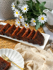 Kek Buah Kukus, a traditional Malaysian steamed fruit cake filled with dried fruits, nuts, and spices, enjoyed during celebrations.