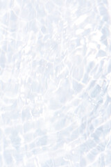 Obraz premium White water with ripples on the surface. Defocus blurred transparent white colored clear calm water surface texture with splashes and bubbles. Water waves with shining pattern texture background.
