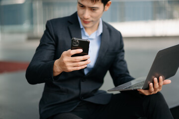 Confident businessman working on laptop,tablet and smartphone at her workplace