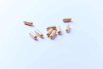 Lutein capsules. Dietary supplement on bright paper background. Soft focus. Close up. Copy space.	