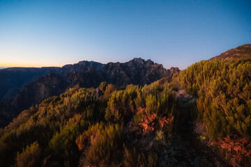 Hiking on the highest peak of Madeira Pico Ruivo next to the cottage Abrigo do Pico Ruivo. Views of...