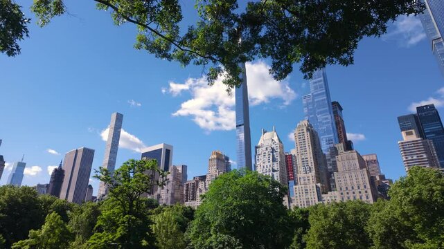 Summer morning in Central Park with view of Billionaires' Row supertall skyscrapers. Midtown Manhattan, New York City