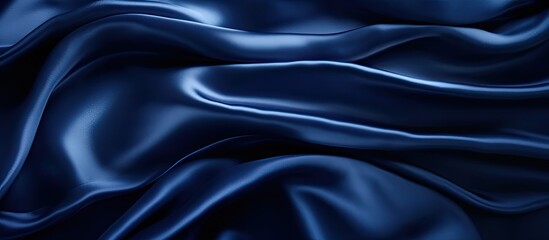Obraz premium Navy blue silk satin texture background with beautiful soft wavy folds, creating a dark, elegant copy space image ideal for your design.