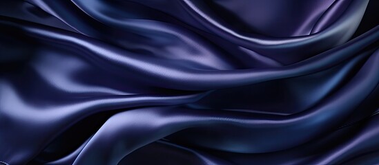 Fototapeta premium Luxurious dark blue silk satin background with soft folds, ideal for adding text or design with copy space image for a variety of occasions like birthdays or holidays.