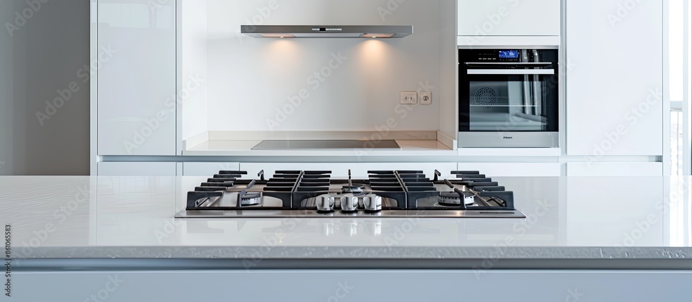 Poster Counter with white cupboards and modern built in appliances placed in light stylish kitchen with gas cooker in spacious apartment. with copy space image. Place for adding text or design