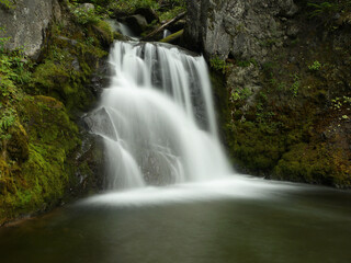 Waterfall in the forest in New Zealand, mysterious scene long exposure time