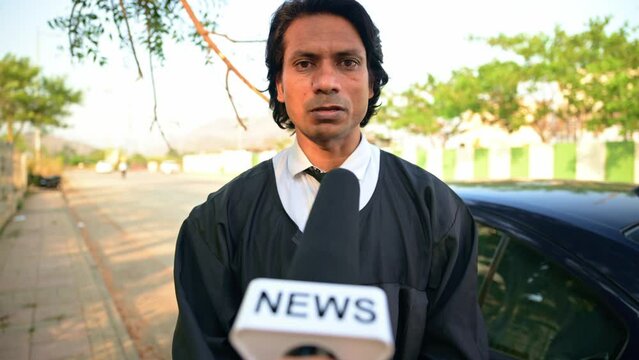 Lawyer giving interview by news reporter outdoors