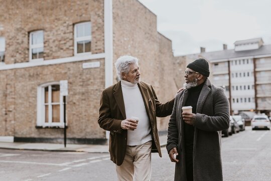 Friends walking down street in British town