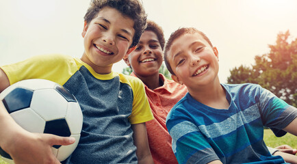 Soccer, friends and portrait of children in park with ball for playing, having fun and sports outdoors. Childhood, youth and happy boys for games on holiday, vacation and weekend together in nature © Reese Coop/peopleimages.com