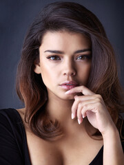 Studio portrait, woman and hand for hair care, beauty or cosmetics and confidence for glow. Aesthetics, wellness and healthy growth by dark background with pride for salon treatment or transformation