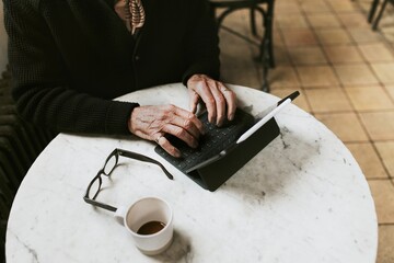 Man working on digital tablet at coffee shop