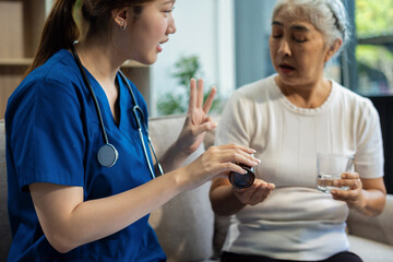 Obraz premium young caregiver assists her elderly woman patient at a nursing home. senior woman is assisted by a nurse at home.