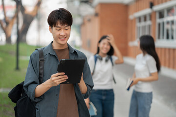 Students Reading Books In University Campus.