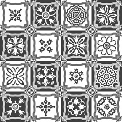 Seamless checkered patchwork pattern of tiles with black and white ornaments