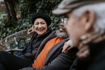 Happy old friends sitting on a park bench