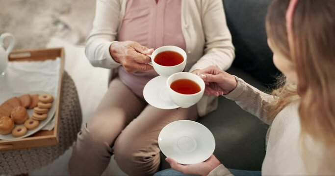 Tea cup, cheers and drink for woman in home, living room and bonding on weekend and relax. Toast, warm coffee or beverage with snacks, elderly female people or biscuits for breakfast in nursing house
