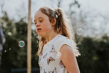 Down Syndrome girl playing in the backyard