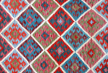 Texture of iranian traditional handmade wool carpet with geometric pattern