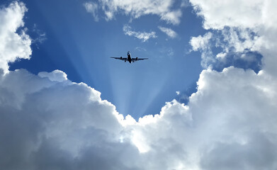 Airplane flying on blue sky and white cloud.