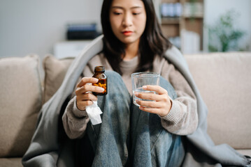 woman holding bottle with pills on hand going to take medicaments prescribed by his physician.