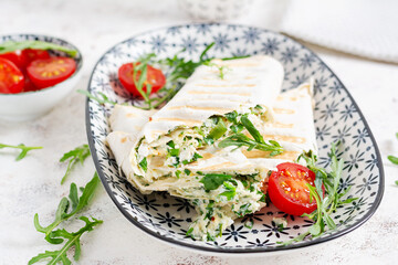 Tasty breakfast with lavash. Mexican cuisine. Trending food with pita bread, cheese, tomatoes and spinach.