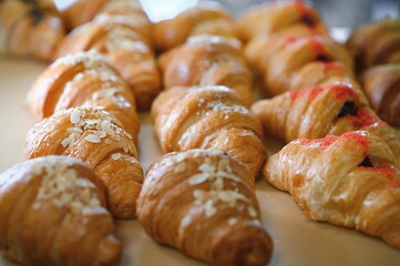 Croissants in a bakery. Cooking pastries in a pastry shop. French crispy croissants close up