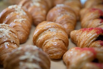 Croissants in a bakery. Cooking pastries in a pastry shop. French crispy croissants close up