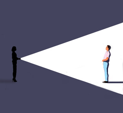 Woman shining flashlight on man