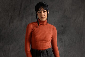 Woman in dulled orange turtleneck sweater, autumn apparel fashion design