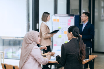 business engage in a brainstorming session, analyzing charts and diagrams. Colleagues, cheerful and proud, celebrate their achievements together.