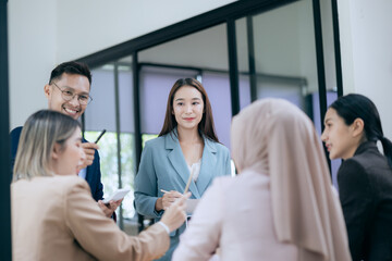 Fototapeta premium in corporate offices in Asia Business woman and man, they work together to plan a project. Analyze charts on laptop and discuss creative ideas with confidence and happiness.