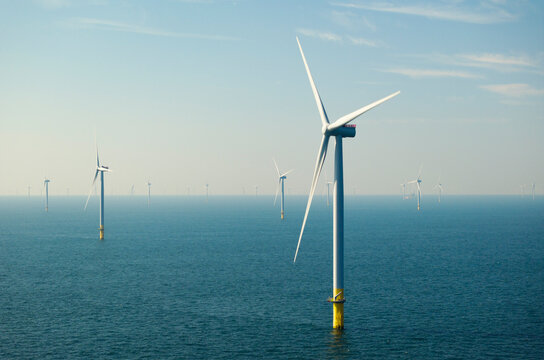 Offshore wind turbines under blue sky in North sea 