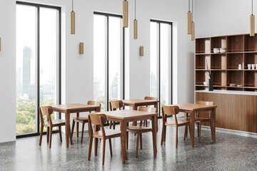 Minimalist cafe interior with dining table, bar counter near panoramic window