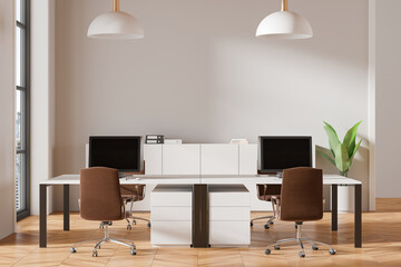 Cozy coworking interior with pc monitors on tables, panoramic window