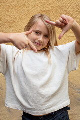 young pretty girl making frame with hands