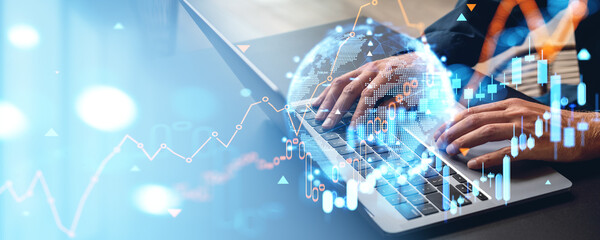 Businessman using laptop, global business market and rising candlesticks