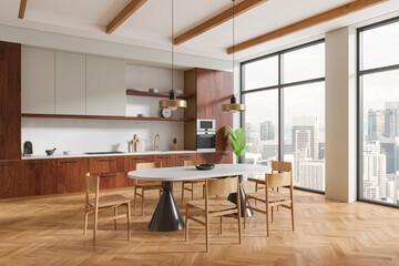 Luxury home kitchen interior with dinner table, cooking cabinet and window