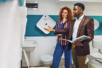Fototapeta premium Salesman is talking with a customer who is choosing the goods.