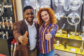 Portrait of young couple who owns small business bath store. Man and woman work in partnership.