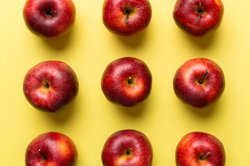 Many red apples on colored background, top view. Autumn pattern with fresh apple above view