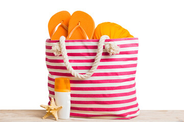 Fototapeta premium Stylish bag with beach accessories . Summer holiday concept. Top view of beach bag with sunscreen cream with space for text