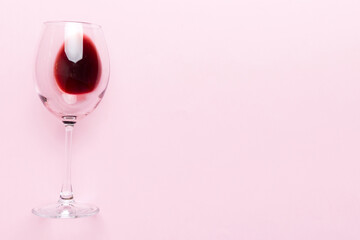 One glasses of red wine at wine tasting. Concept of red wine on colored background. Top view, flat lay design