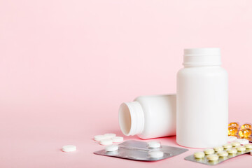 Medicine for treatment HIV infection. Pills and capsules and battle on the table. Different colorful tablets at colored background with copy space